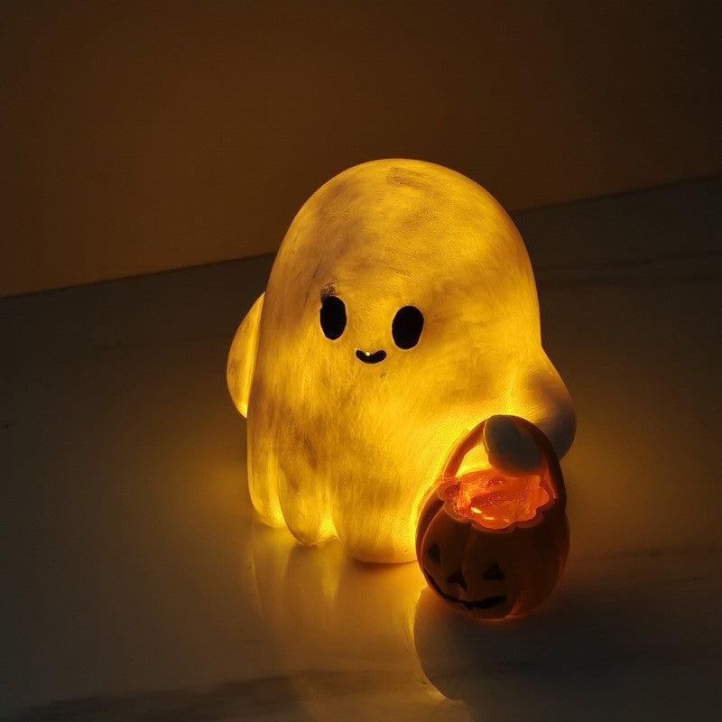 Halloween ghost with a glowing night light on its middle finger