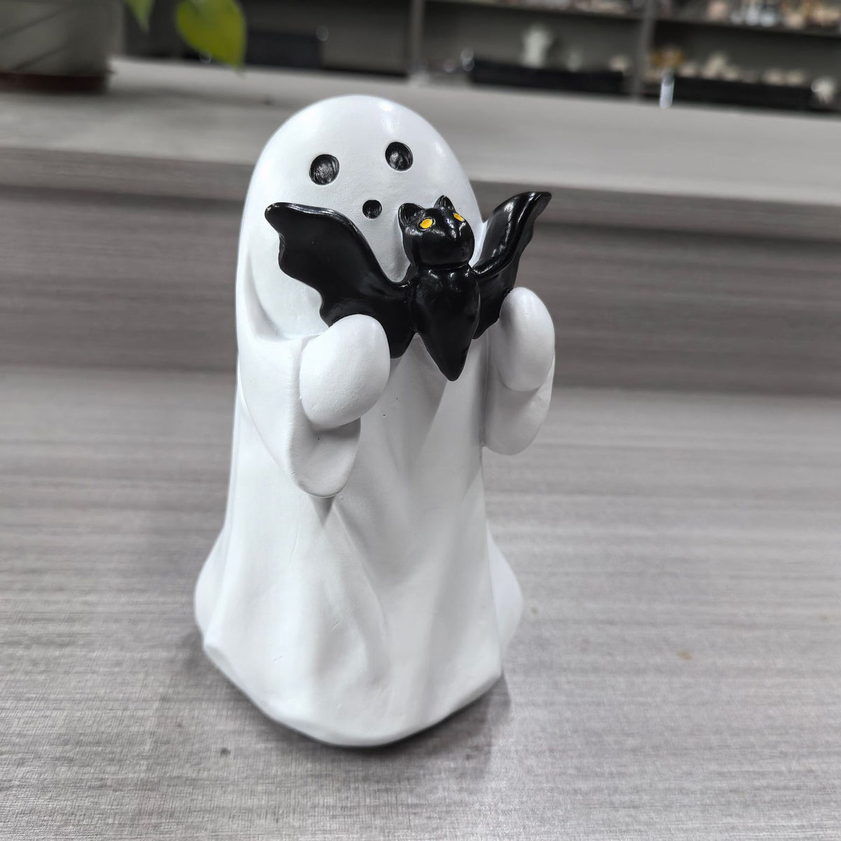 Halloween ghost with a glowing night light on its middle finger