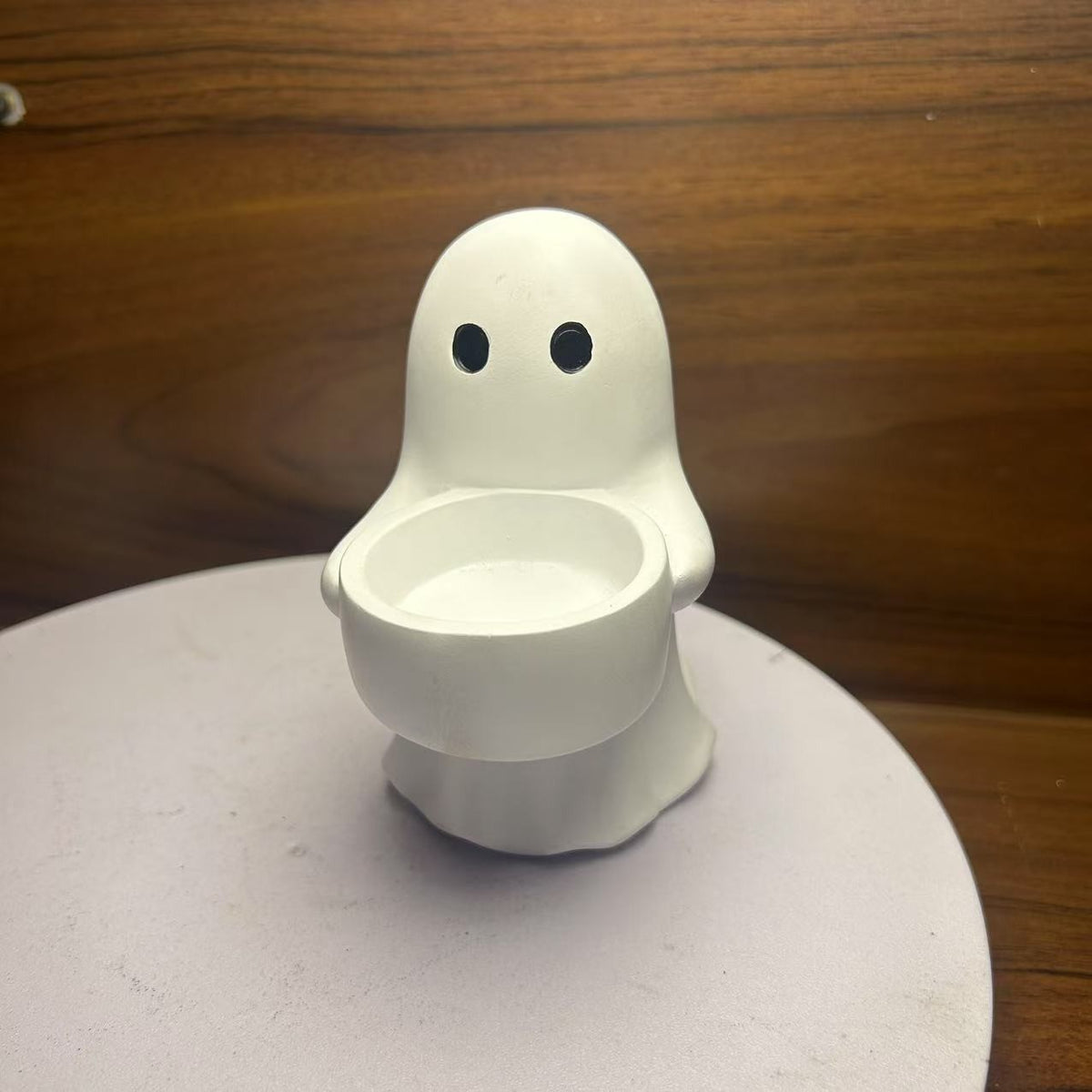 Halloween ghost with a glowing night light on its middle finger