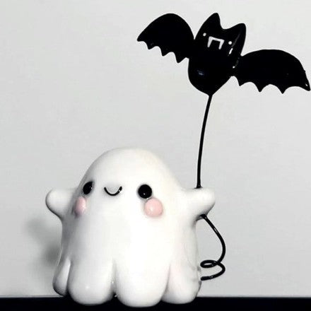Halloween ghost with a glowing night light on its middle finger